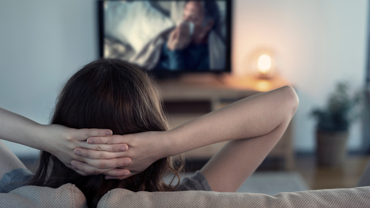 Woman watching tv at home